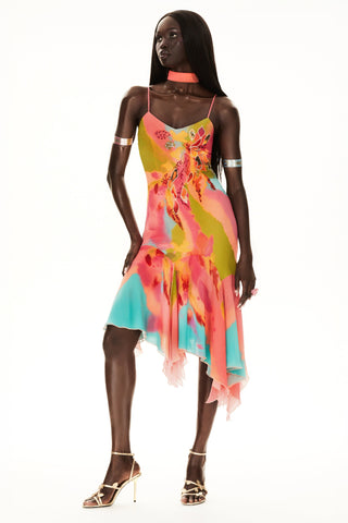 Cybersweeties Model wearing a colourful evening dress with floral patterns on a white background. The Tulipa cocktail dress. 2000s, vintage style 