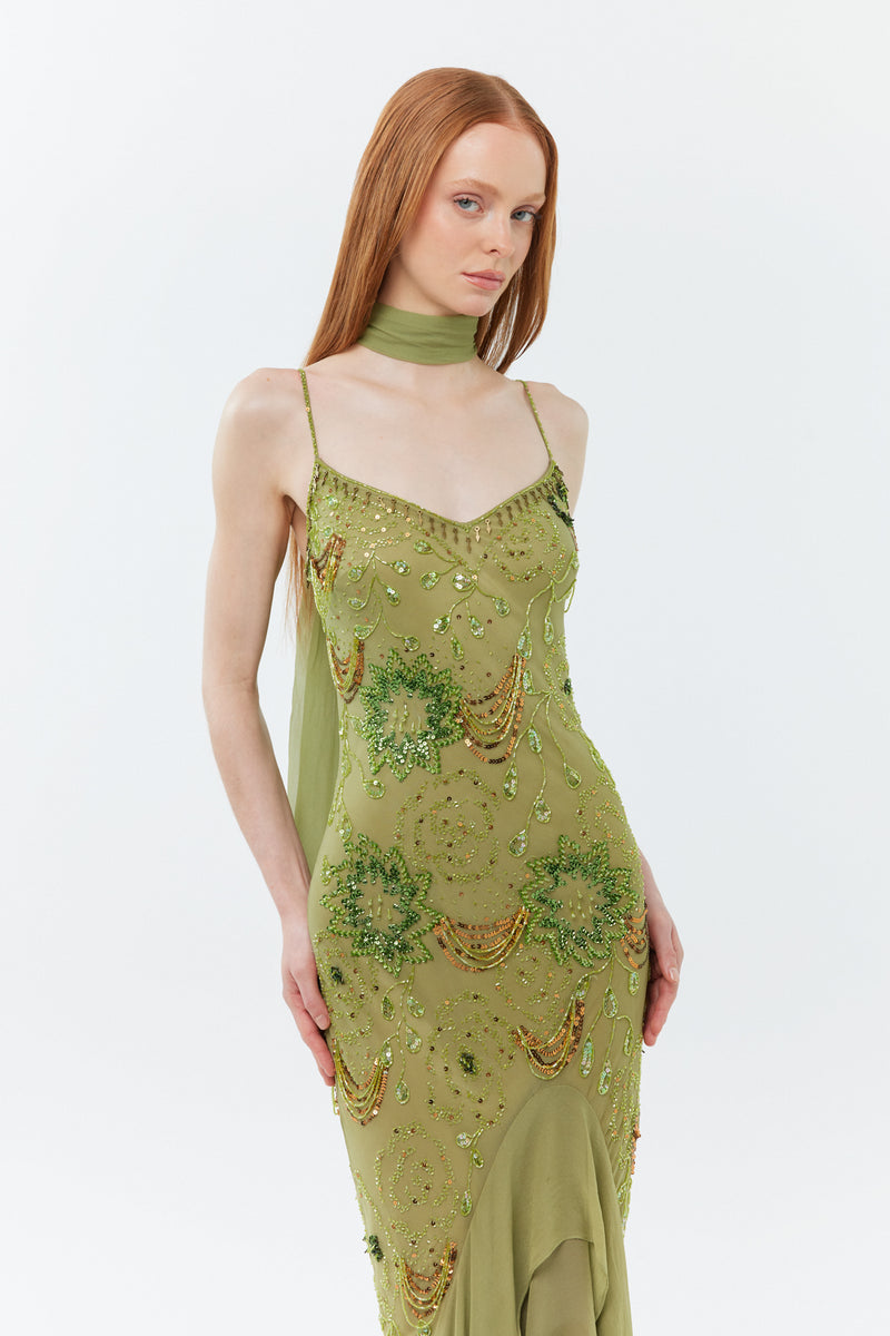 Model in vintage style sage green silk bias-cut gown for garden party wedding guest outfit.