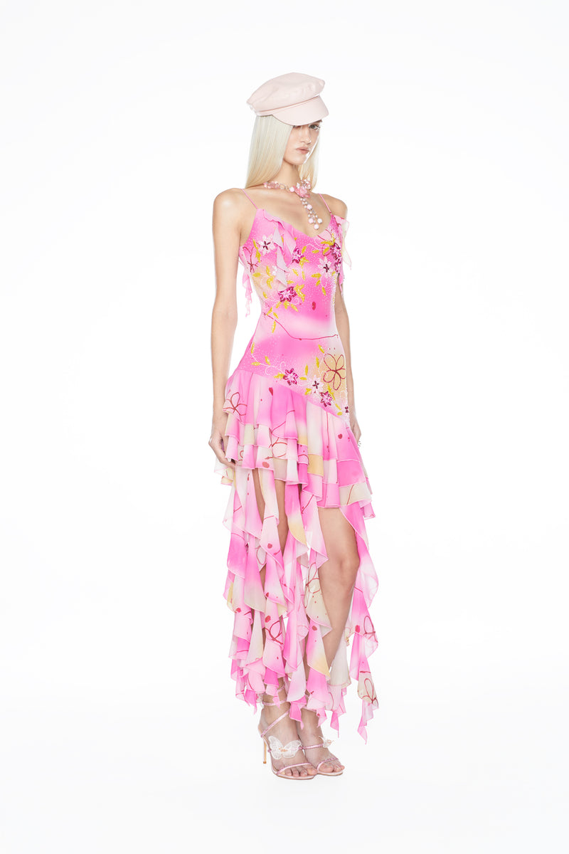 Effortlessly chic Y2K-style mini slip dress with a playful ruffled hem and light-catching hand embellishments.