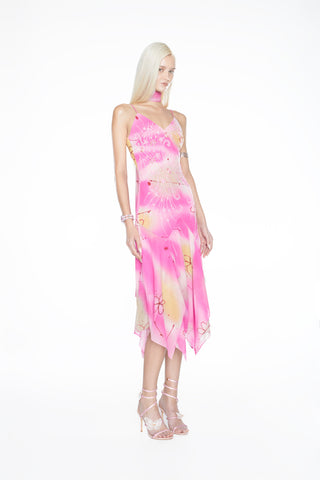 Dynamic shot of an artisan-crafted evening gown displaying shimmering light-catching crystals and a soft, fluidly moving hem.