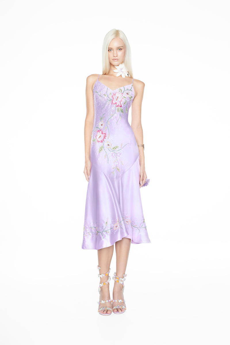 Whimsical fairy aesthetic light purple satin gown featuring hand-beaded flowers and a fluid, bias-cut silhouette. Light purple satin formal dress adorned with delicate hand-crafted beaded blooms, including a concealed zip and matching shawl.