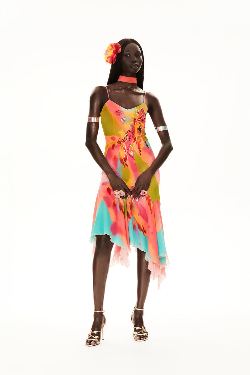 CyberSweetie Tulipa gown featuring hand-painted flowers, glistening gem embellishments, and a handkerchief hem. Whimsical 2000s-inspired hand-painted floral gown with a handkerchief hemline, perfect for a standout wedding guest look.